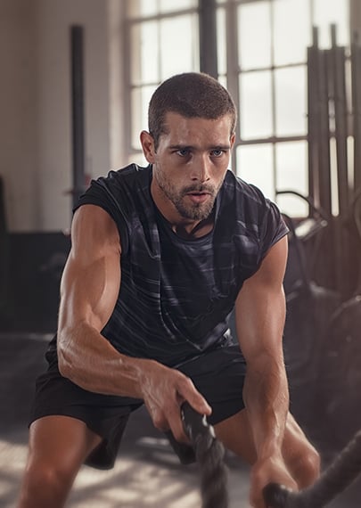 Man working out pulling on rope