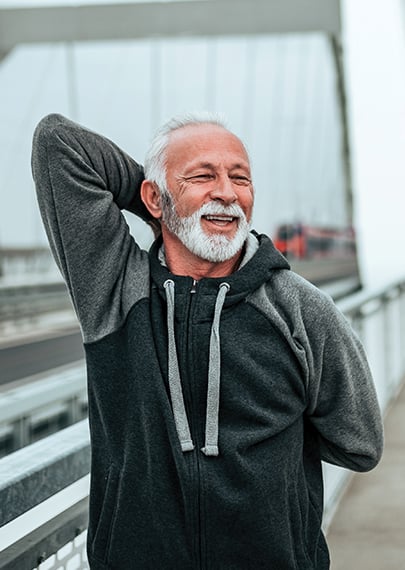 Older man demonstrating shoulder and arm stretches